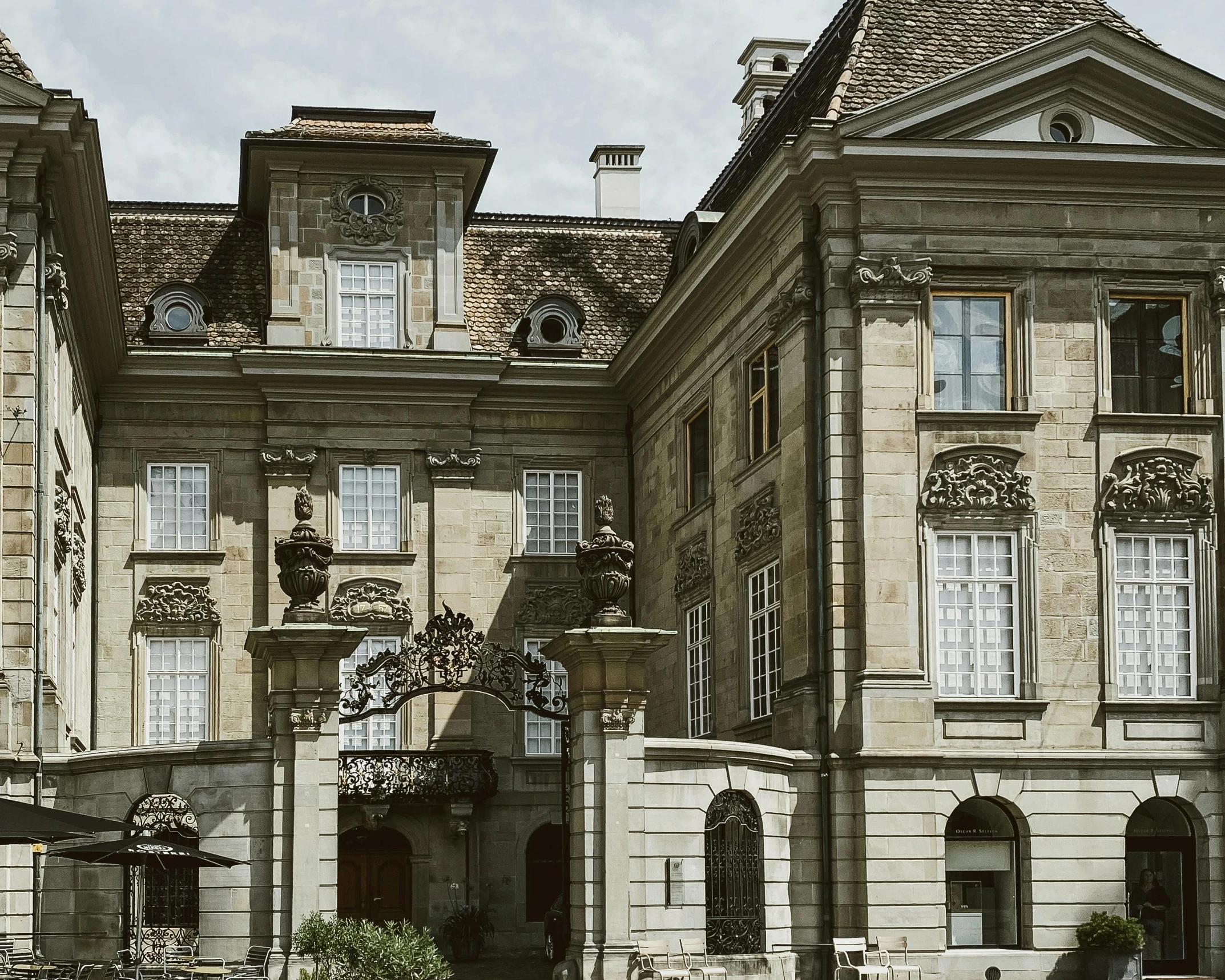 large stone building with clock faces on the front