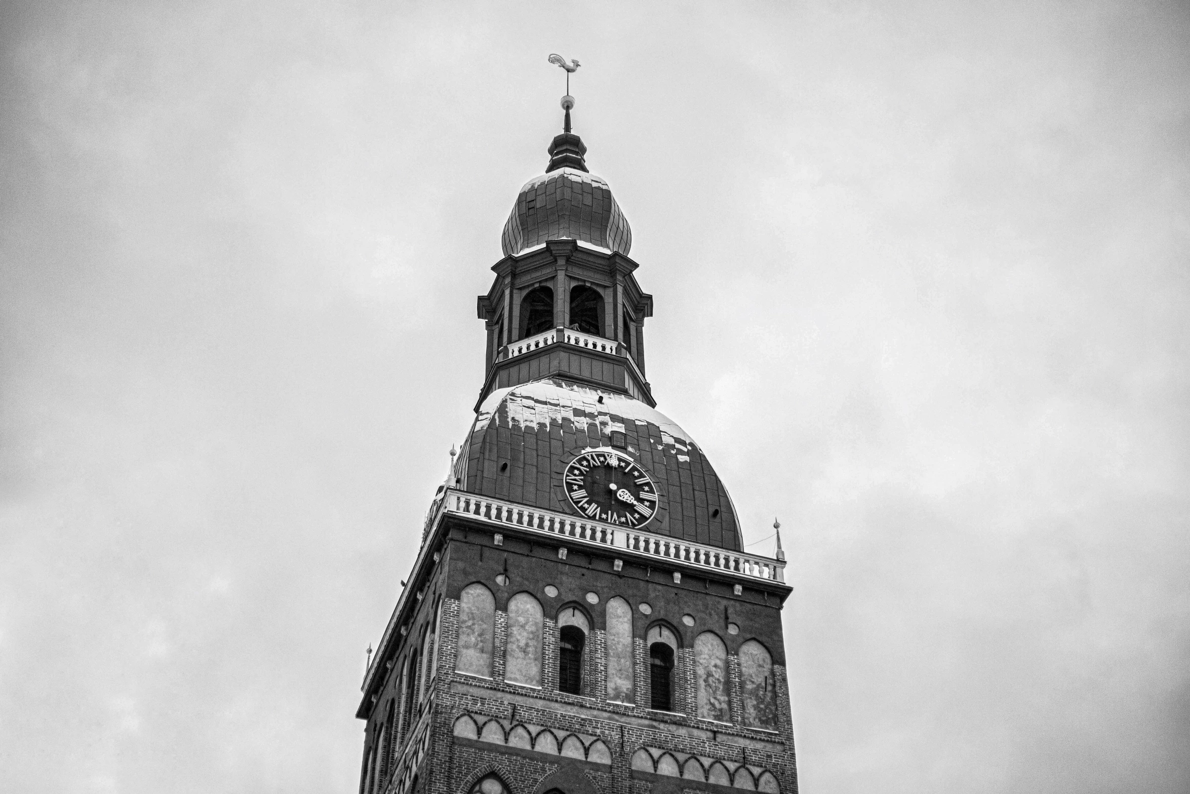 an ornate clock tower is under an overcast sky