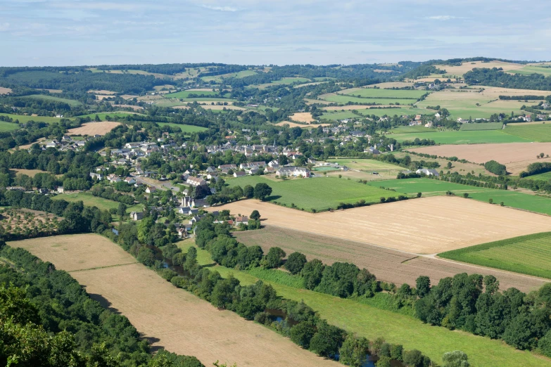 a view of some land and trees in the countryside