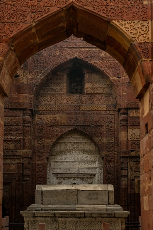 a stone memorial in an arched brick wall