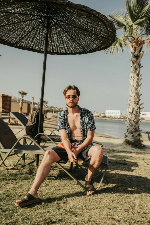 a man is sitting in his chair with his legs crossed