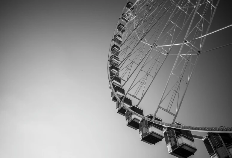 a black and white image of a ferris wheel