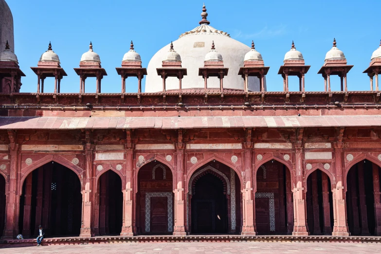 large building with several small archways and bell tops