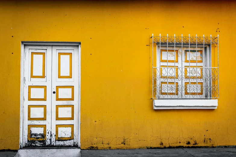 there is a yellow and white wall with a white door