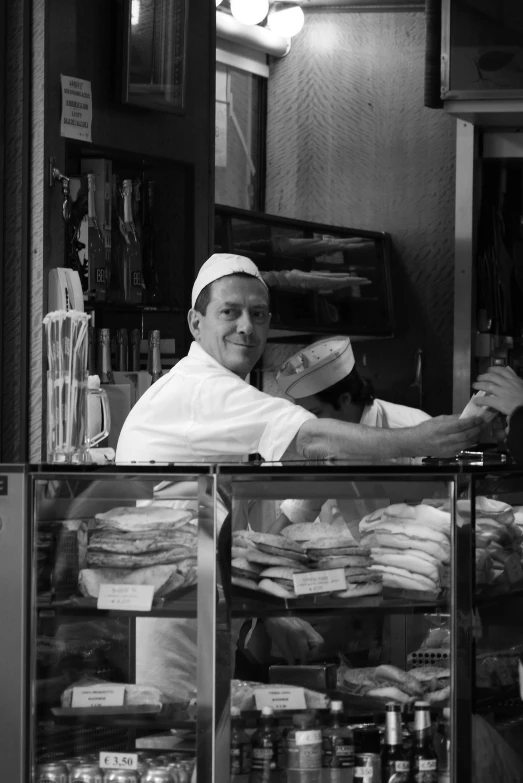 a man working at a store in a store with many food items