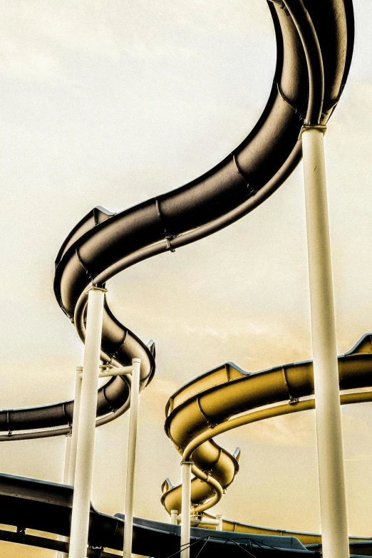 a black and yellow slide with an orange tube
