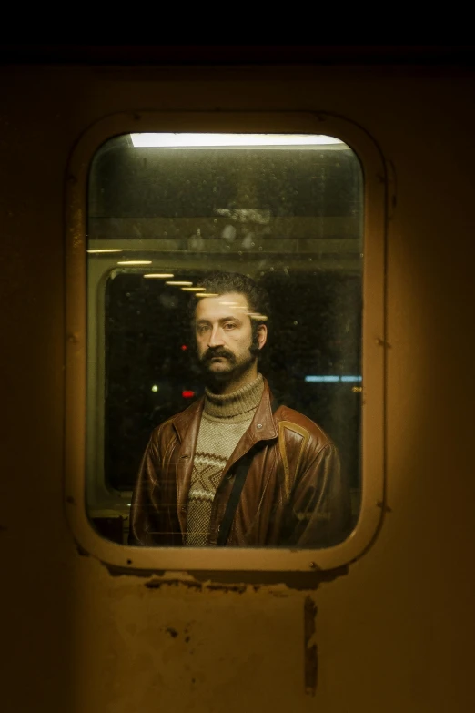 a man wearing a beard and wearing a leather jacket