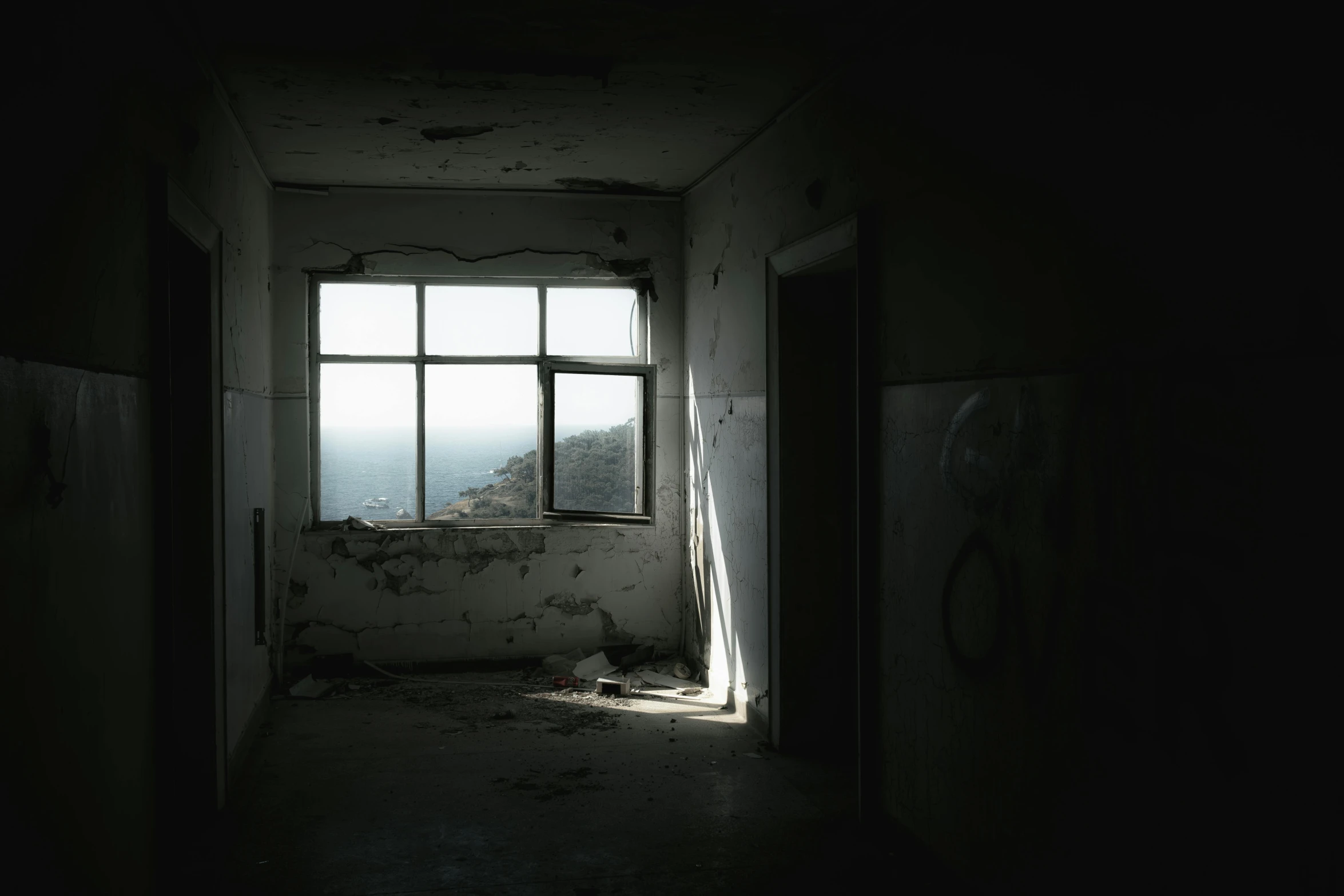 an abandoned and desolate building has a very big window