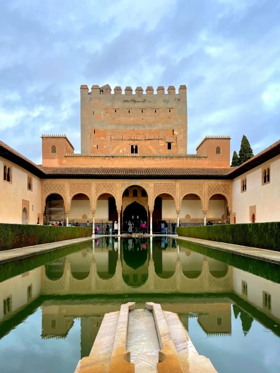 courtyard of building with large pond in front of it