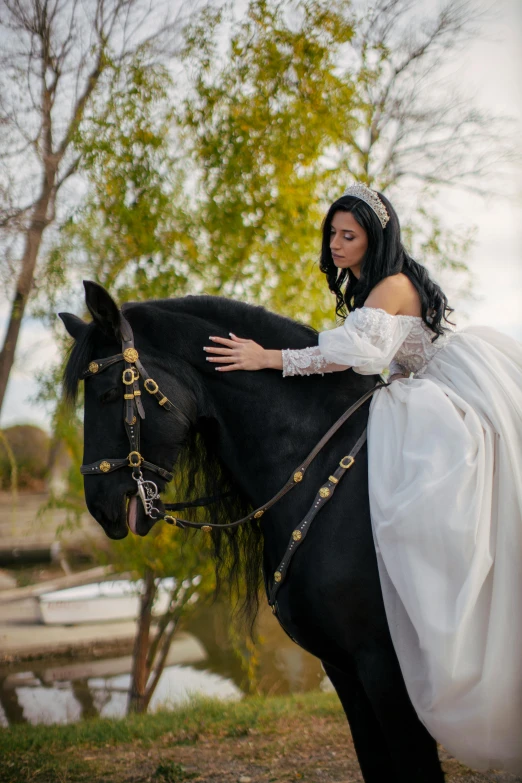 a woman wearing a dress and riding a horse