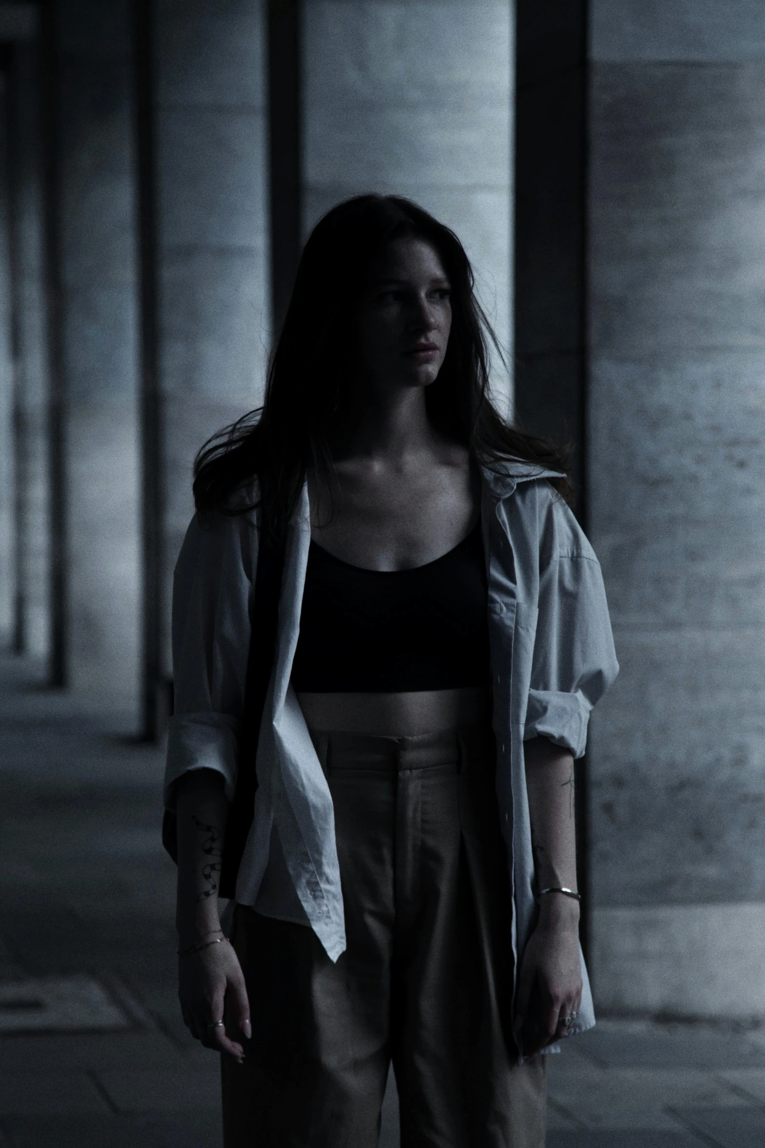 a woman standing outside wearing a white coat