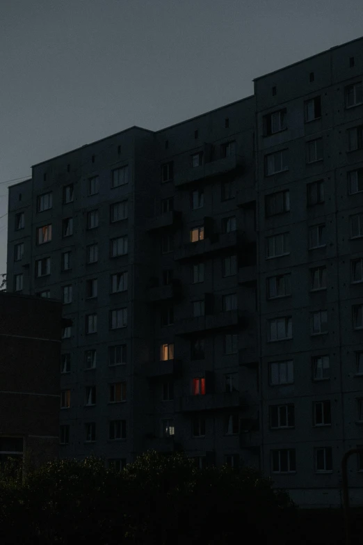 the moon is shown in front of some dark buildings