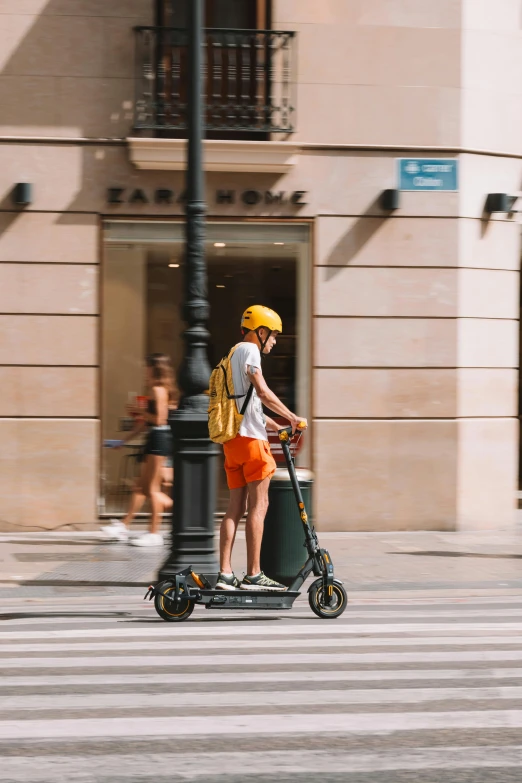 a person on a motorized scooter rides down the street