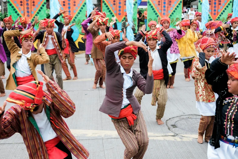 a group of people with colorful headscarves dance