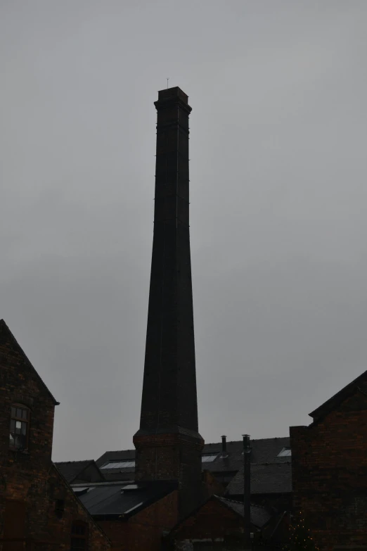 an old brick structure stands tall in a gloomy sky