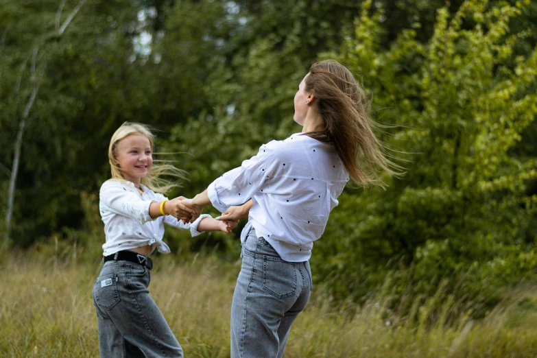 a little girl and another small  in a field