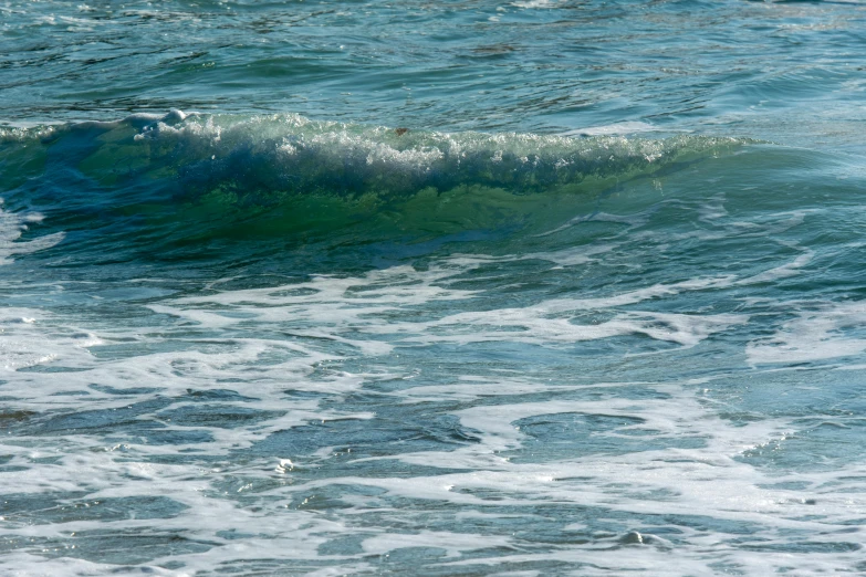 waves crashing towards the shoreline on an ocean beach