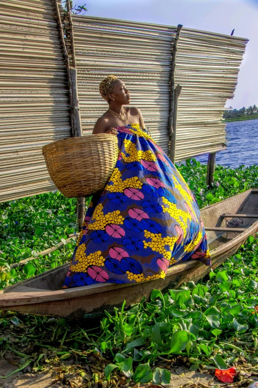 a woman sitting in a small boat with straw baskets on it