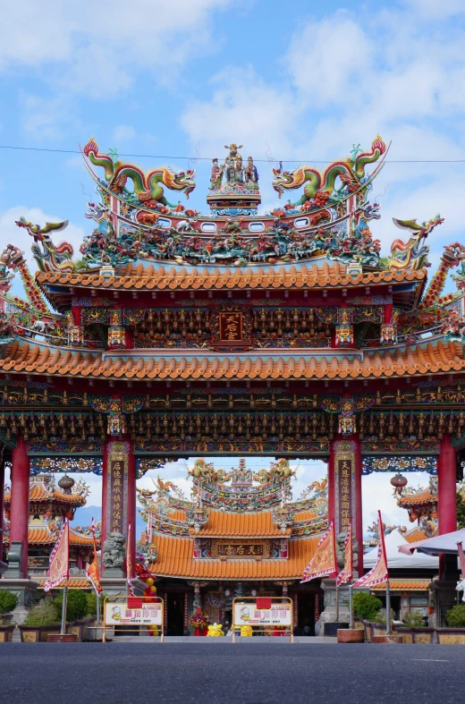 a chinese building with many dragon statues on it