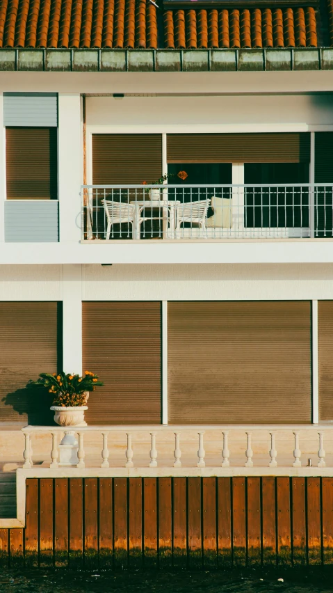 there is a building with a balcony and a fence