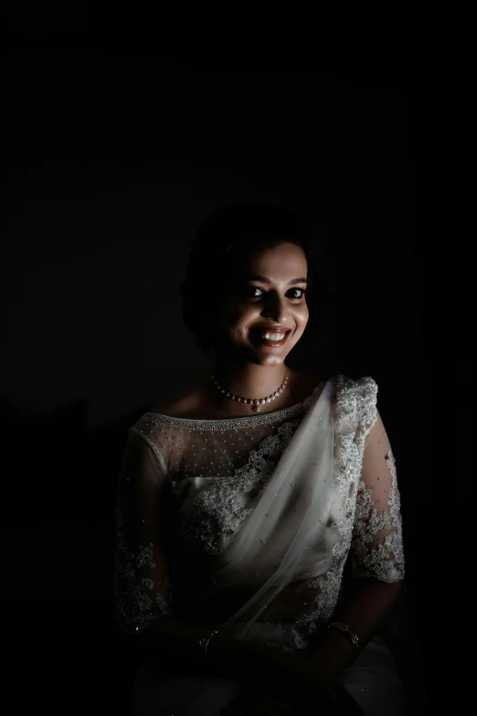 a beautiful woman smiling in a dark room