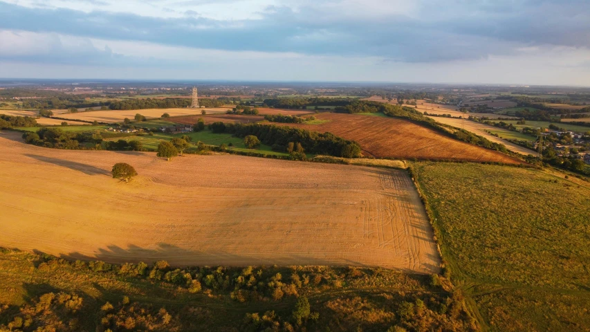 an aerial s of a farm field surrounded by green trees