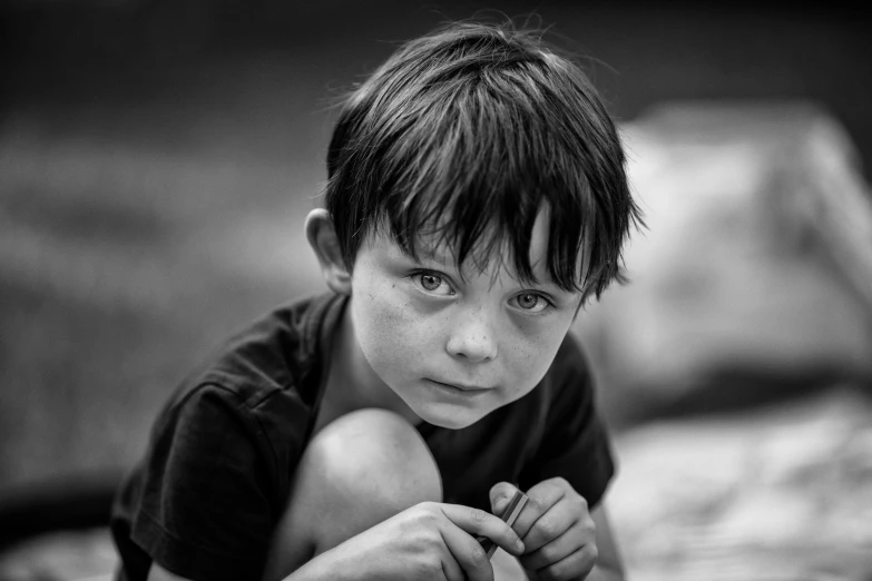 the boy is posing for a black and white po