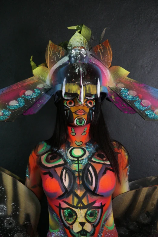 a woman with very colorful body paint and elaborate designs