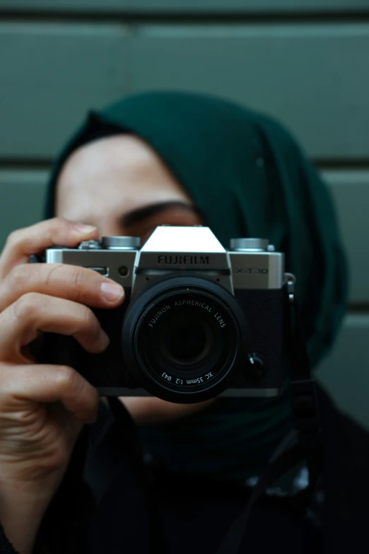 a woman is taking a picture with her camera