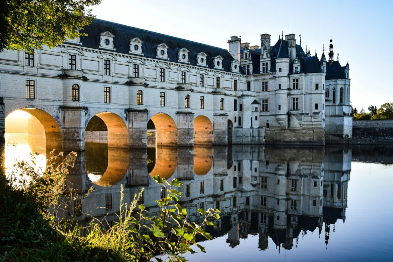 the front side of the building has arches over water