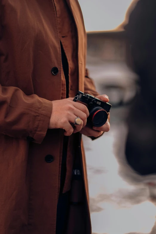 a man standing in the rain with a camera