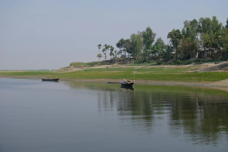 a group of boats floating on top of a lake