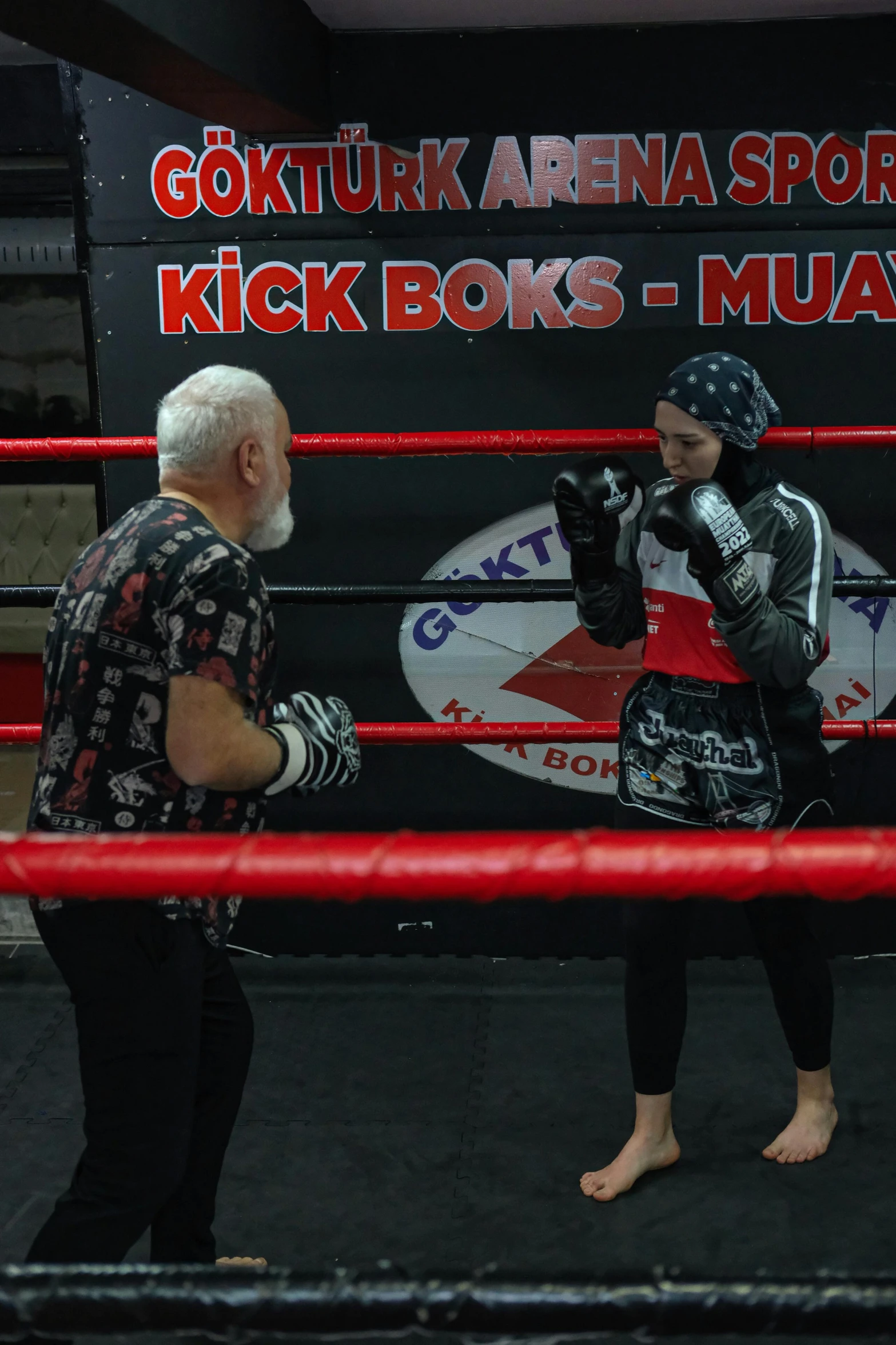 two people on a boxing ring facing one another