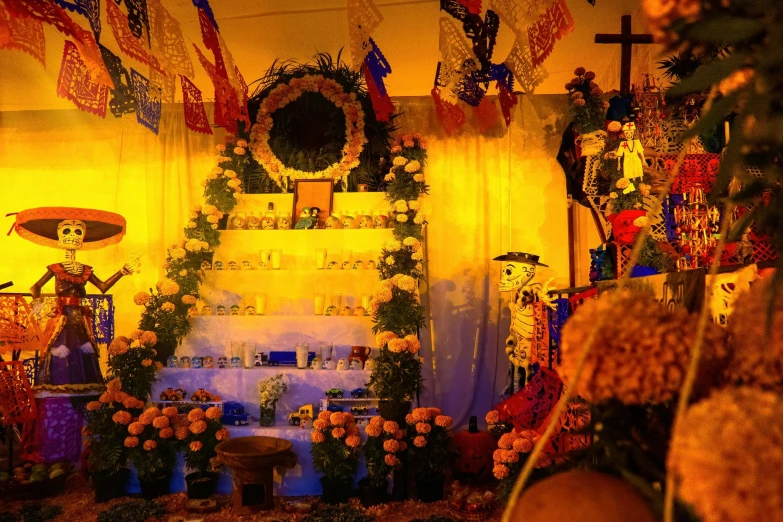 an altar with flowers and flags and decorations