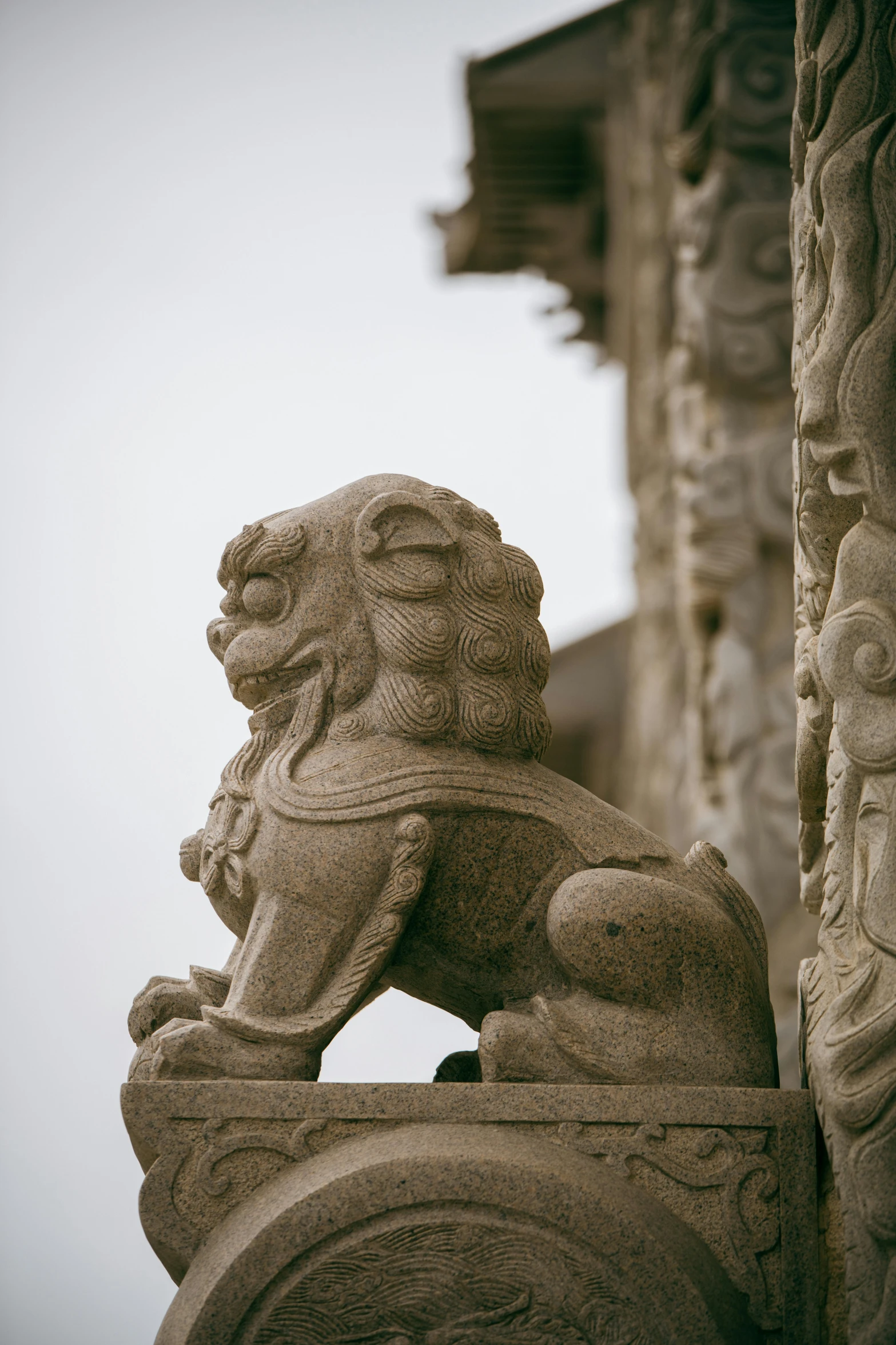 a stone lion statue at the entrance to an old building