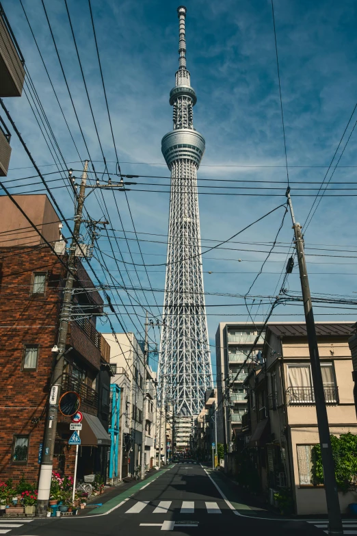 a street scene with an electric fence on the corner and a tall building in the middle