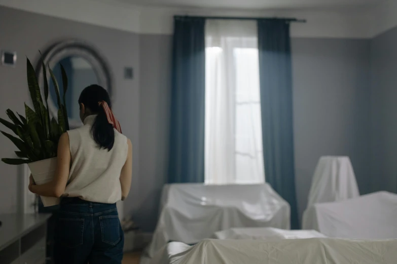 a woman is standing in front of her bedroom