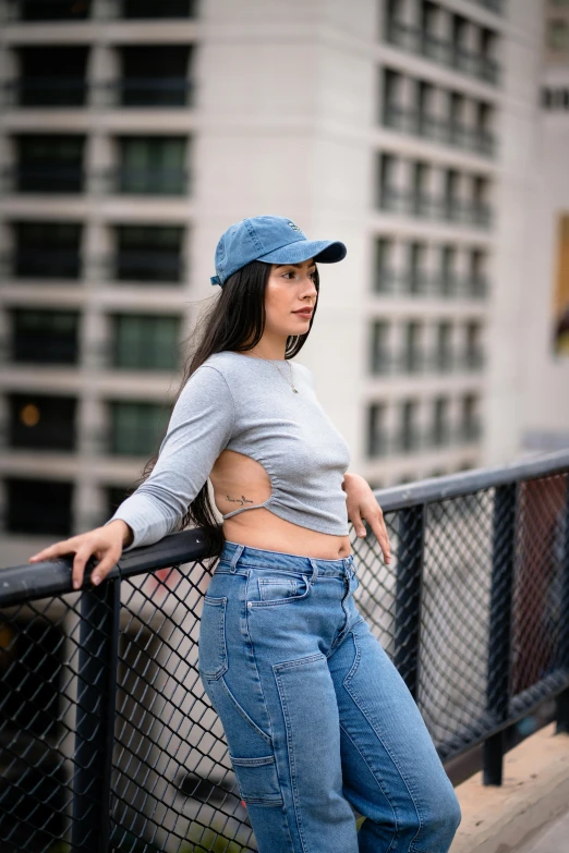 a girl is leaning against a railing outside