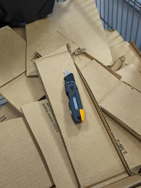 the small tool is laying on top of the cardboard