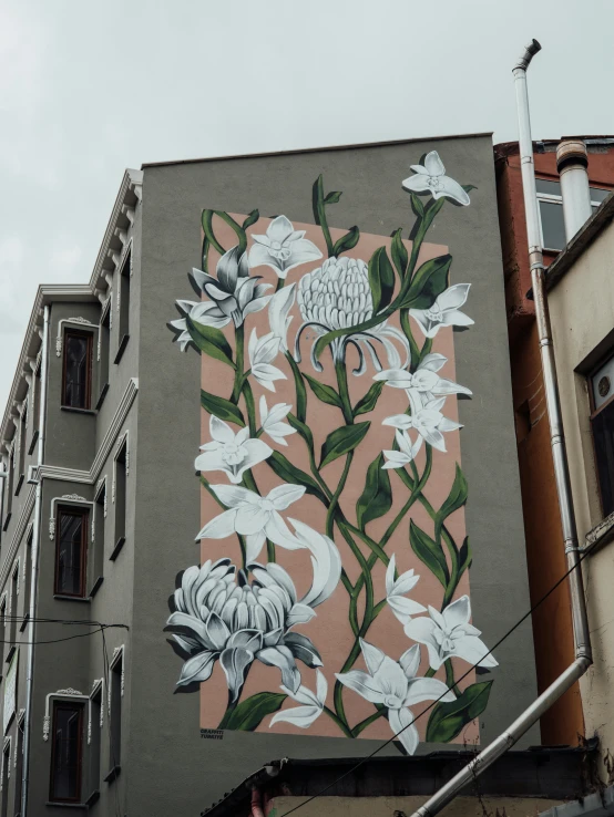 an art piece of a flower on the side of a building