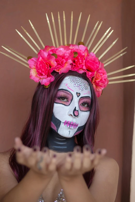 woman with skull makeup and flowers behind her face