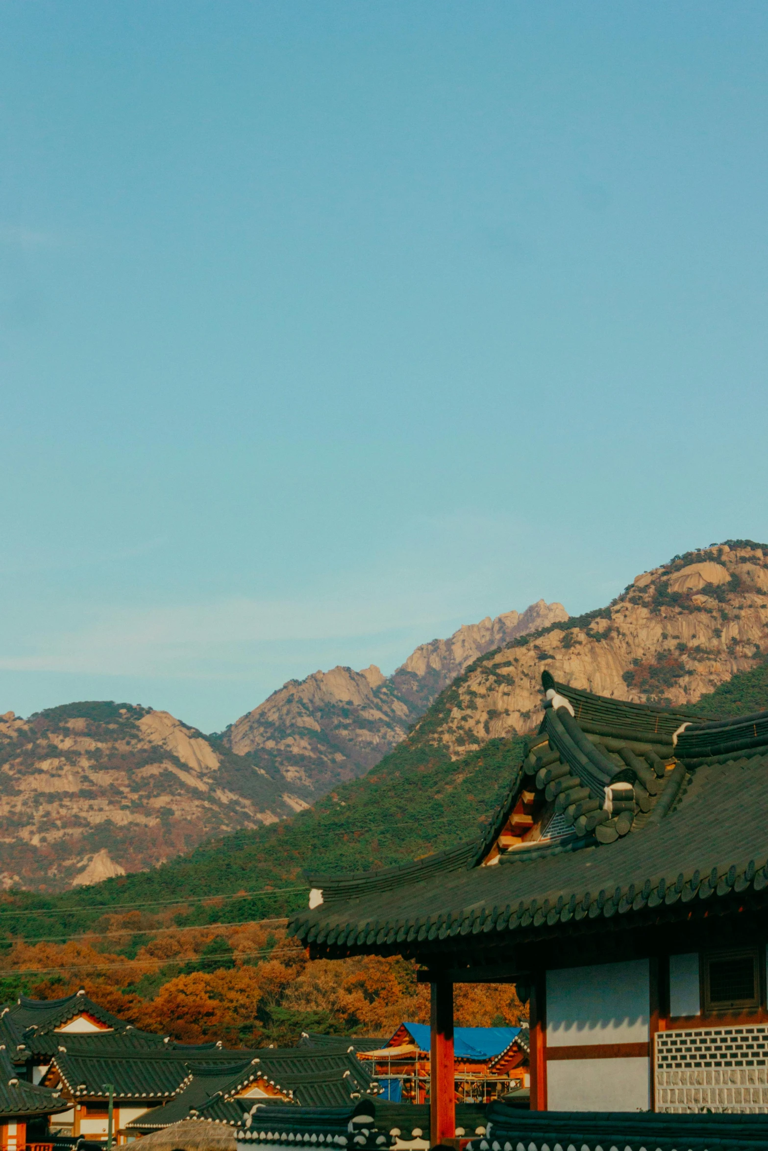 two old buildings on a hill in an oriental village