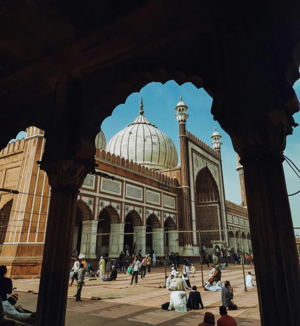 a building with a huge dome and many people sitting in it