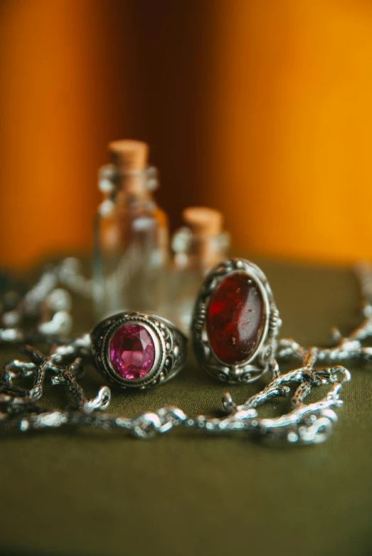 two pairs of ruby stones hanging from silver chains