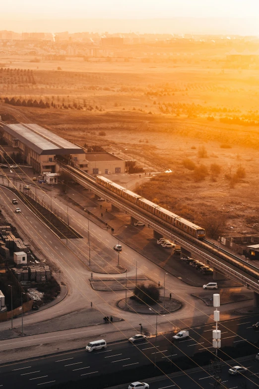 an aerial view of the train station near the highway