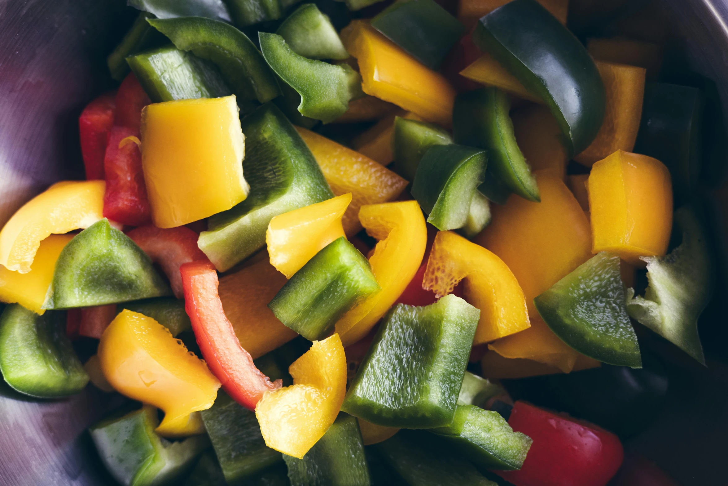 cut bell peppers and cut jalapenos in a metal bowl