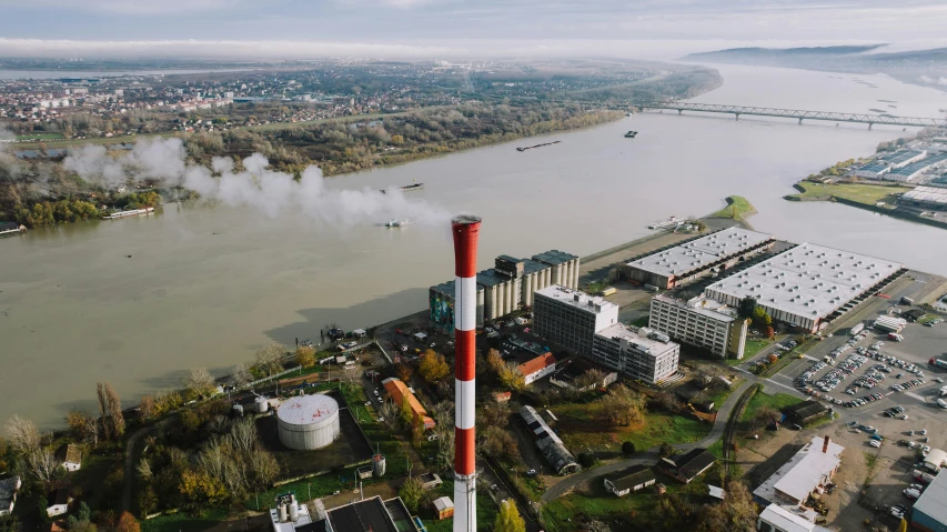 an aerial s of a factory plant with smoke pouring out of it