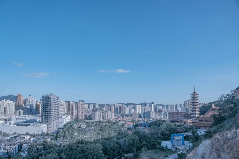 a view from a hill that has tall buildings on it