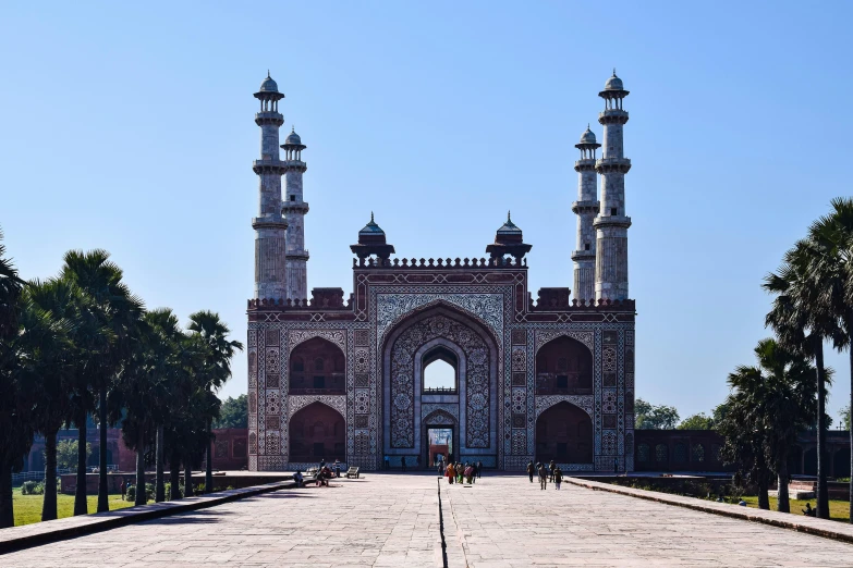 the gate to a small stone building with two large towers