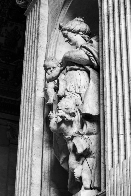 statue in column of building with black and white po